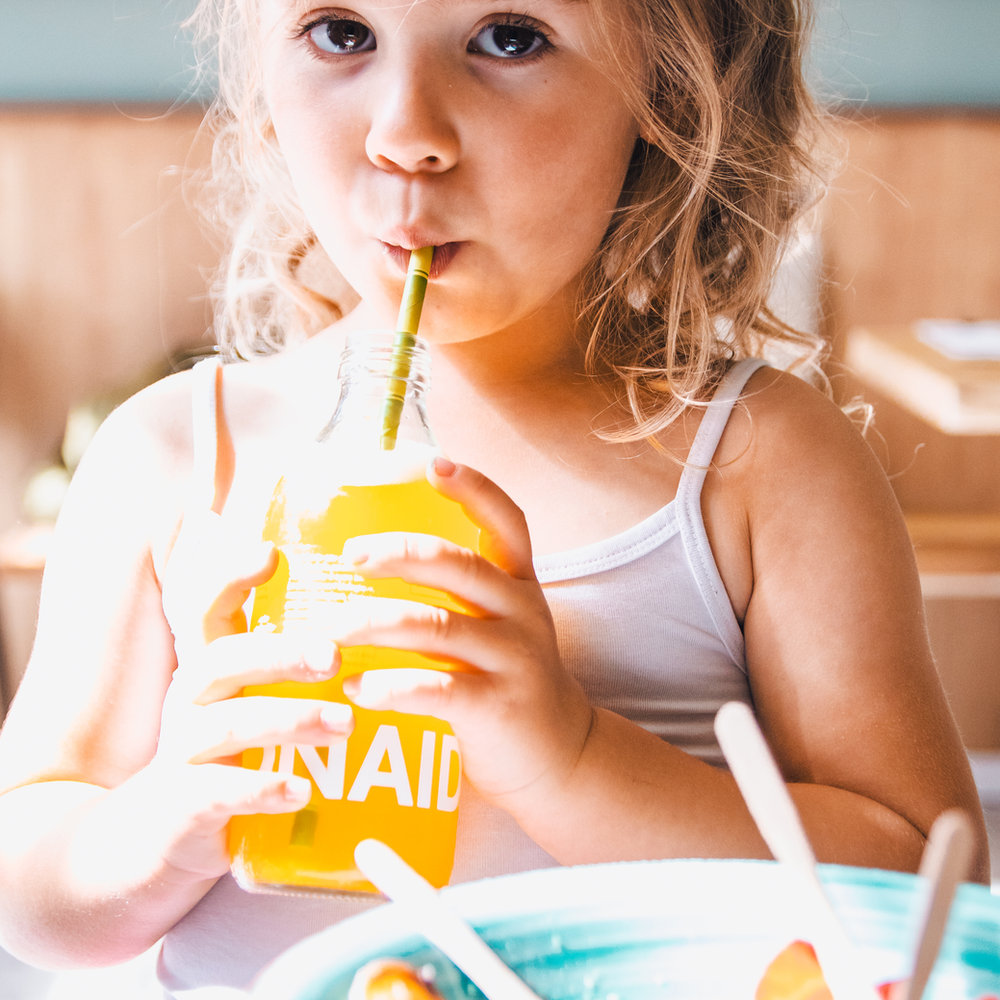 A child enjoying a fresh juice at ANNA